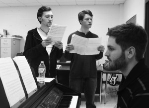 TRISTAN LAWRENCE and JEREMIAH SMITH rehearse with vocals teacher Matthew Hanson at a recent a cappella practice. Becca Heilman/The Omniscient