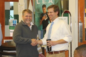 RODDY STORY (right) is congratulated by fellow social studies teacher Skip Thibault. Story was named Teacher of the Year April 5. Quinn Kerscher/The Omniscient