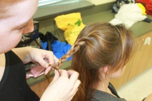 Freshman Hunter Koch helps dancer Katha Rudy with her hair for the dance concert. Taylor Maloch/The Omniscient.