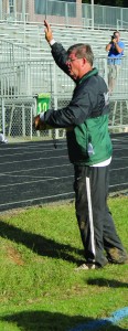 Richard McDonald, track and cross-country coach, stands beside the track encouraging runners to do their best. Vanessa Jones/The Omniscient.
