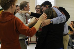 Members of the English department surround Kathy Greenlee, who was named Teacher of the Year Feb. 27. Jessica Clayton / The Omniscient.
