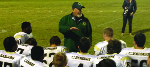 FOOTBALL COACH BILL HALL gives a speech to the team after a game against Orange. Elizabeth Thompson/The Omniscient
