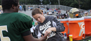 ATHLETIC TRAINER JACKIE HARPHAM tapes junior TYSHUN TINNENS’ hand before a game.