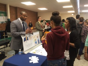 An admissions counselor from North Carolina Wesleyan College talks to senior Kyla Hatch and guidance counselor Sonia Logan at the college fair. Becca Heilman/The Omniscient