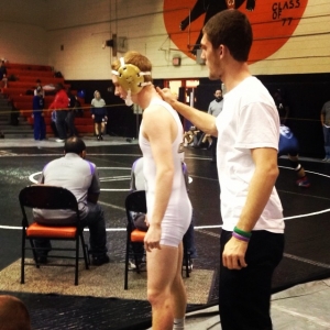 Senior Josh Carver gives junior Grayson Bryant a pat on the back before his match at the Orange High School Wrestling Tournament #wrestling #NHS