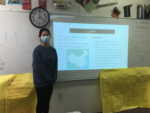 Senior Sam Medeiros gives a presentation on Chinese culture at an AACC meeting.